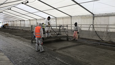 Photo of several people working in a tent