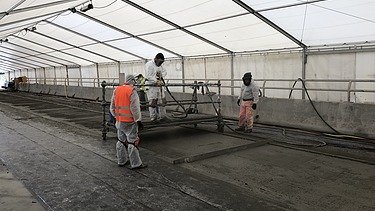 Photo of several people working in a tent