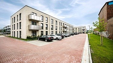 Exterior view of the residential building with a view of the parking spaces