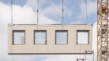 Photo of prefabricated MOLENO exterior wall element on crane, ready for installation