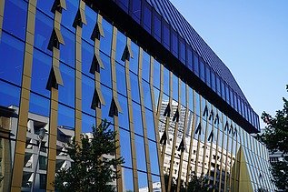 Exterior view of the new Axel Springer building in Berlin with focus on the glass front with gold accents