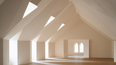 Interior view of the converted attic in Straubing town hall with light wood structure and modern finish.