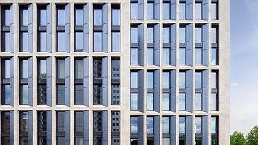 Exterior shot of an office building, focus on the façade.