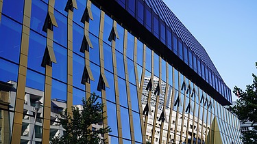 Exterior view of the new Axel Springer building in Berlin with focus on the glass front with gold accents