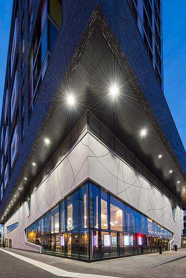 Side view of the building with floor-to-ceiling windows