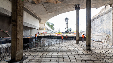 Photo of several people attaching steel rods