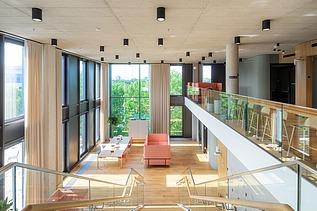 Interior view of an office building with a large open space with seating