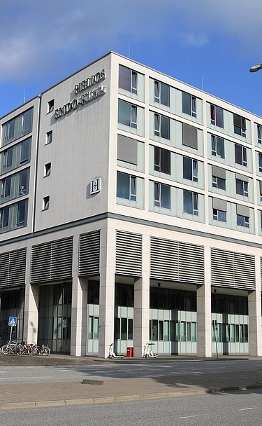 Exterior view of a hospital with a white façade