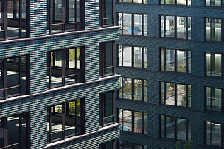 Close-up of the façade of the INK Inspire Neukölln in Berlin consisting of green ceramic tiles