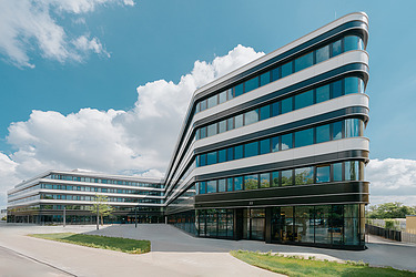 Picture of an office building with a large glass front