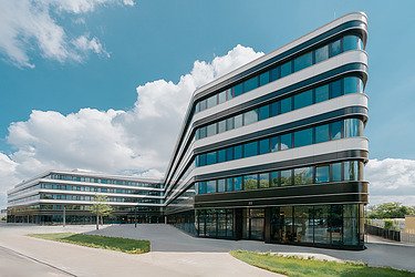 Picture of an office building with a large glass front