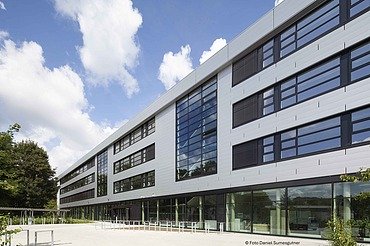 Exterior view of a multi-storey school building with glass front