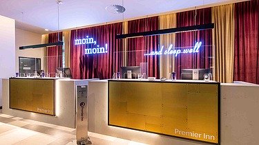 Modern reception area with stylish design at PREMIER INN Hamburg-St. Pauli