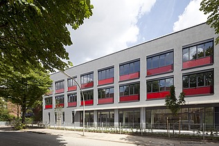 Moderne Schule mit roter Fassadengestaltung und funktionalem Design