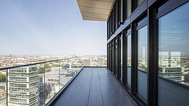 Picture from the balcony of an office building with a view of the city.