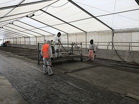 Photo of several people working in a tent