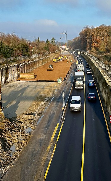 Picture shows a road construction site with construction vehicles