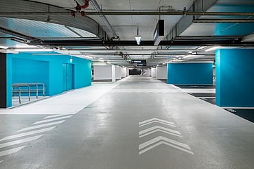 Photo of an underground parking garage with blue tones