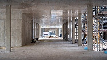 Construction site photo of the interior of an office building, concrete walls can be seen