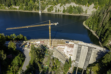 Photo of a dam with crane from the air