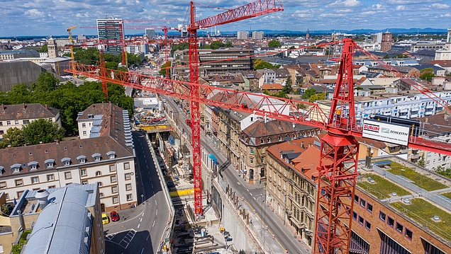 Photo of a large construction site with many cranes in the middle of the city