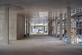 Construction site photo of the interior of an office building, concrete walls can be seen