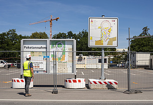 A picture of a building site with an information board