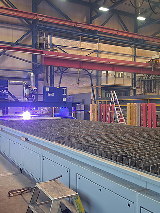 Photo of steel construction production, plate burning and drilling line