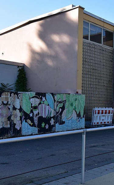 Picture shows a school building and a railing in front of it