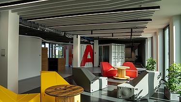 The Innovation Center in Stuttgart, view of an open space with colorful chairs