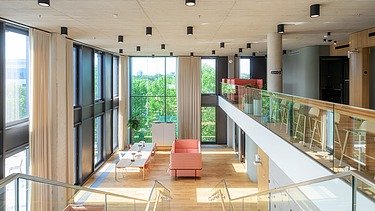 Interior view of an office building with a large open space with seating