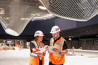Photo of two colleagues in conversation on a construction site
