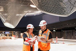 Photo of two colleagues in conversation on a construction site