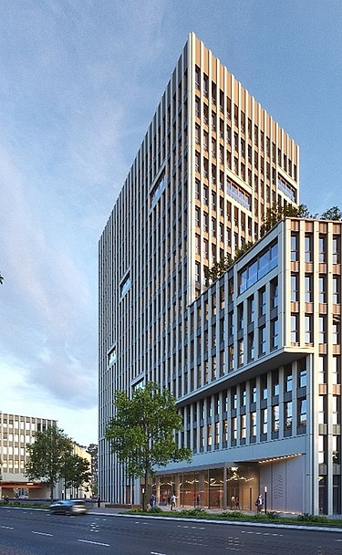Picture shows a high-rise office building with blue sky and surrounded by trees