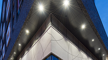 Side view of the building with floor-to-ceiling windows