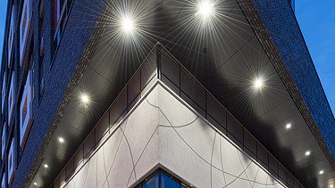 Side view of the building with floor-to-ceiling windows