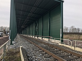 railway track and green tunnel