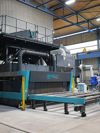 Photo of steel construction production, blasting system with roller conveyor