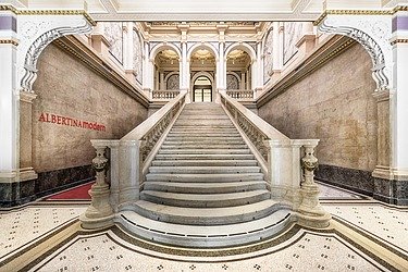Interior of a historic building with large staircase