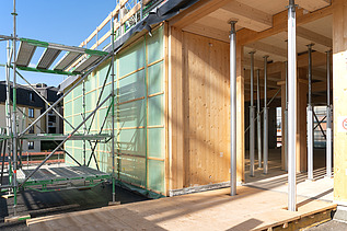 Foto der Montage des UmweltHauses in Nürnberg. Man sieht Holzelemente.