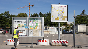 A picture of a building site with an information board