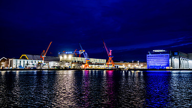 Front view of the shipbuilding hall in Kiel at night 