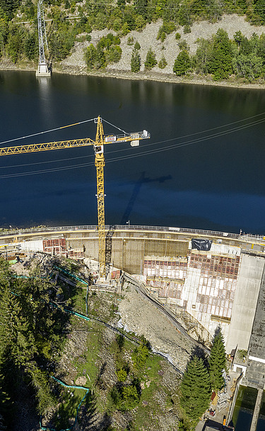 Photo of a dam with crane from the air