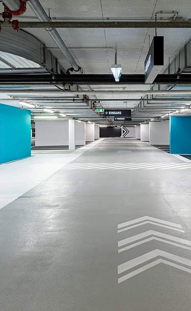 Photo of an underground parking garage with blue tones