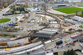 Aerial view of a construction site with railroad line and underpass