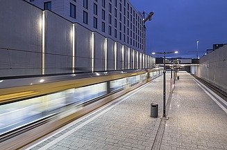 Subway stop at night with subway passing through