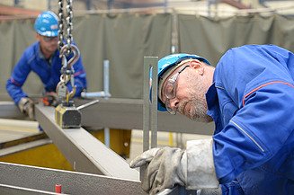 Two workers working with steel