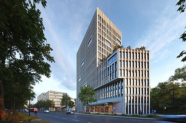 Picture shows a high-rise office building with blue sky and surrounded by trees
