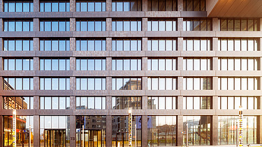 Close-up of an office building in warm sunlight.