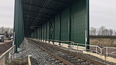 railway track and green tunnel